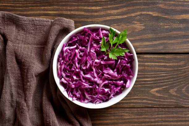 istock Red cabbage in bowl over wooden background 2192271371