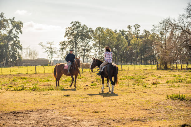 istock Father and daughter riding horseback on a stable 2192272095