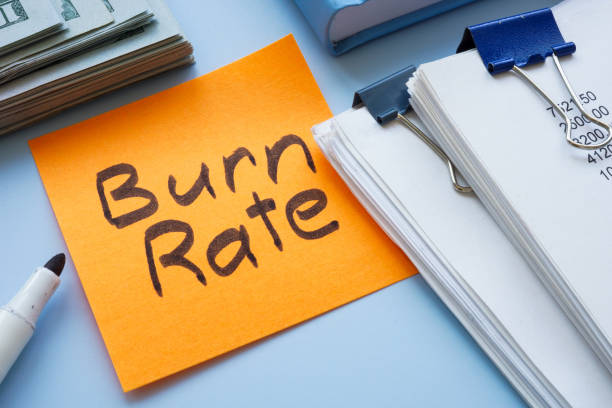 istock Stack of papers, cash, and a sticky note with burn rate. Cash flow management. 2192272146