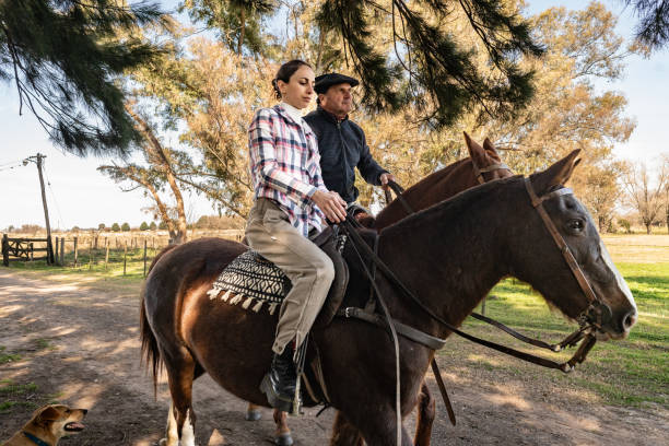 istock Father and daughter riding horseback on a stable 2192272479