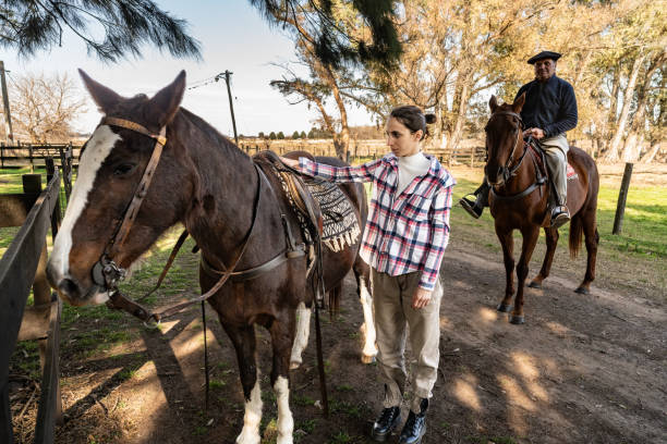 istock Father and daughter riding horseback on a stable 2192272518