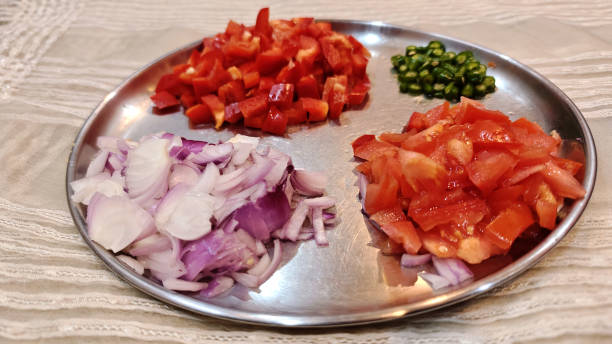 istock Freshly Chopped Vegetables on a Steel Plate for Cooking Preparation 2192273534