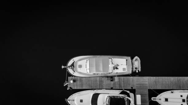 Black and white drone overhead view of a docked boat . High quality photo