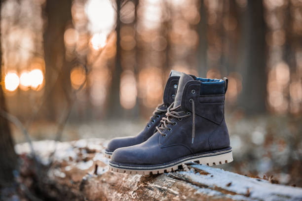 Leather ankle boots placed outdoors. Vintage or old fashioned shoes perfect for hiking