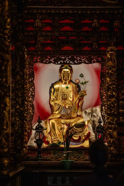 istock Golden Buddha statue in ornate temple setting. 2192276907