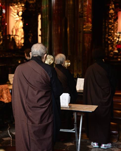 Taipei, Taiwan – November 18, 2023: Monks lead a prayer at Longshan Temple, a Chinese Buddhist temple in Taipei, Taiwan.
