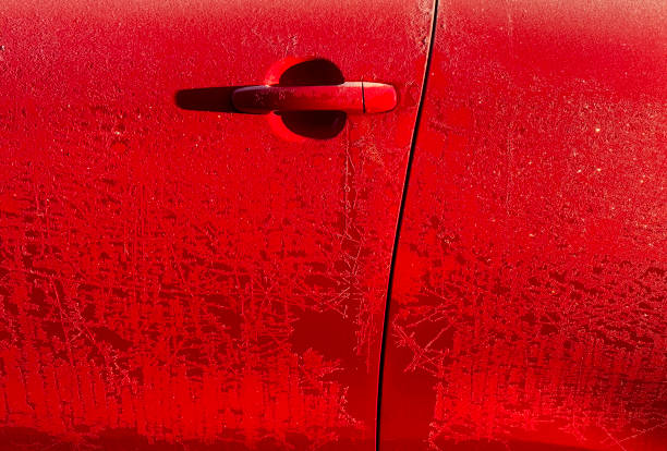 Frost pattern on a red car door on a cold winter's morning