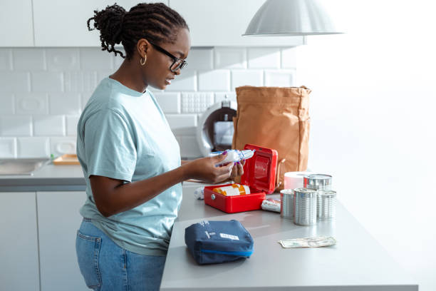 istock Woman prepares a first aid kit in a modern and organized kitchen 2192278628