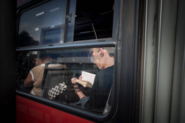 Woman Reading on Public Transport Metrobus Linea 1, Mexico City, Mexico