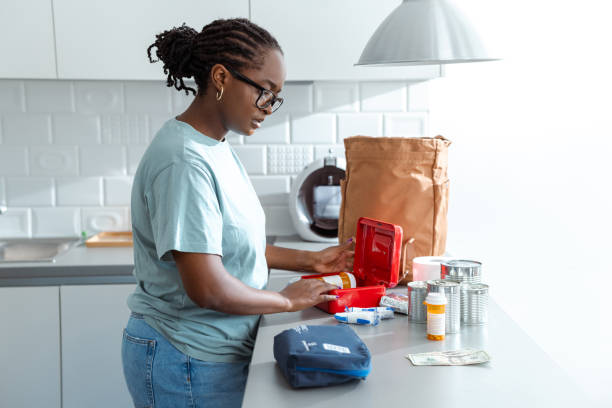 Woman prepares a first aid kit in a modern and organized kitchen