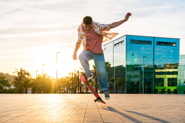 istock Handsome young skater doing acrobatic trick at sunset 2192279394