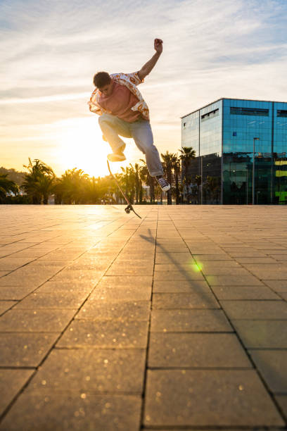 istock Handsome young skater doing acrobatic trick at sunset 2192279467
