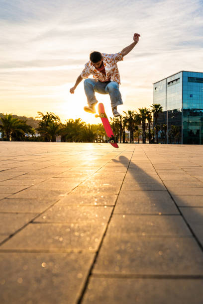 istock Handsome young skater doing acrobatic trick at sunset 2192279532