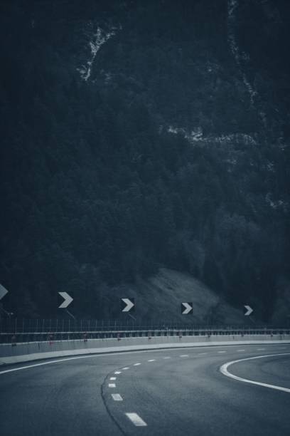 istock Winding mountain road in misty forest 2192279883