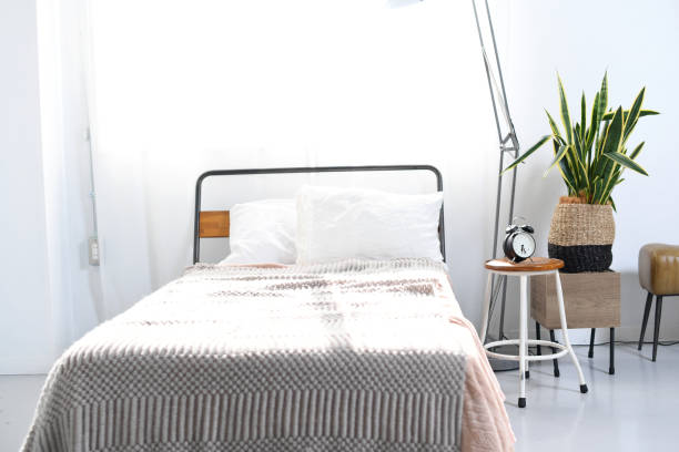 istock An image of a bedroom with sunlight shining through it 2192281120