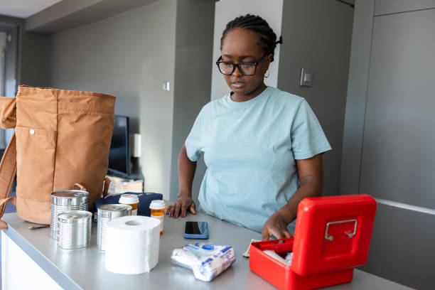 istock Woman organizing a first aid kit at home with essential items 2192281649