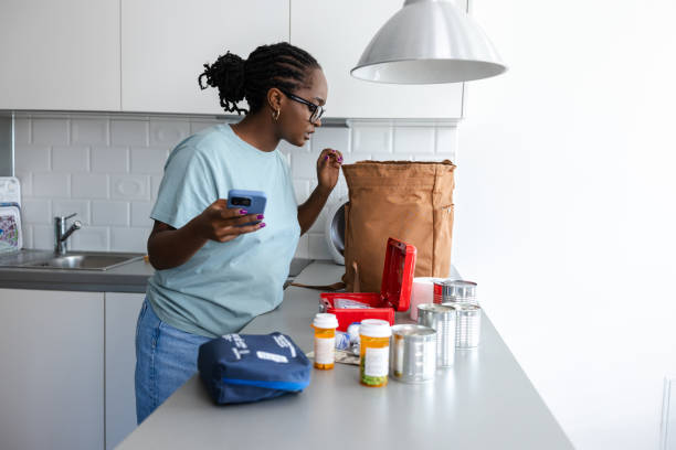 istock Woman organizing emergency supplies on a kitchen countertop 2192281777