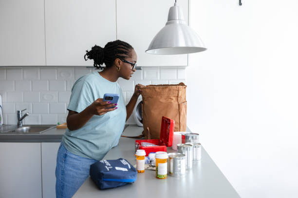 istock Woman organizing emergency supplies on a kitchen countertop 2192281796