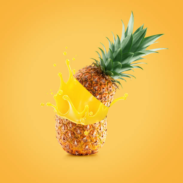 istock pineapple with juice splash on a yellow background 2192283275