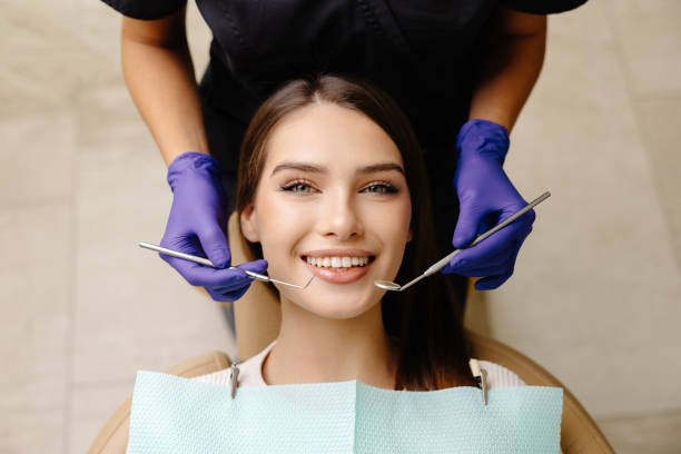 istock Happy patient during a visit to the dentist. The doctor is checking teeth using a dental instrument, ensuring proper oral care in the dentistry clinic 2192283500