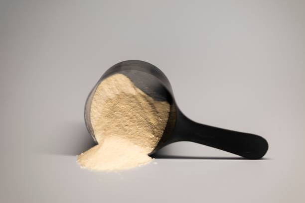 istock Black scoop with protein powder on gray background. 2192284104