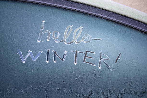 istock 'Hello Winter' written on a frosty car windscreen 2192285089