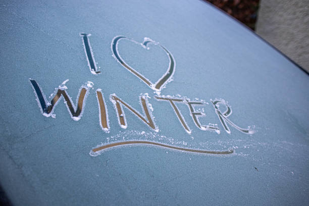 'I Love Winter' written on a frosty car windscreen