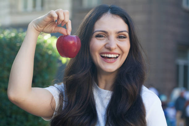 istock Young woman eating an apple 2192285175