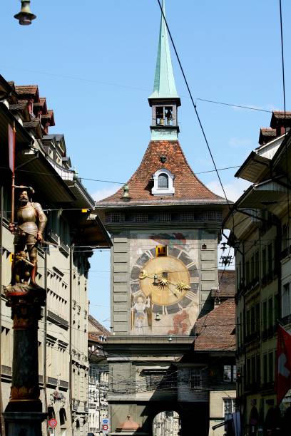 The Zytglogge clock tower in Bern, Switzerland, under a clear blue sky, showcasing historic architecture and intricate clockwork details.