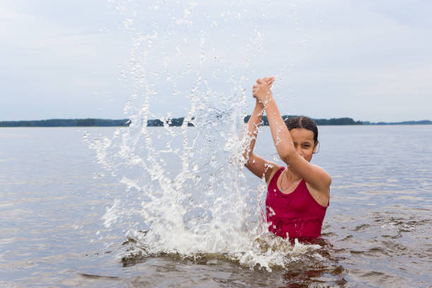 A girl swims in a fresh lake.