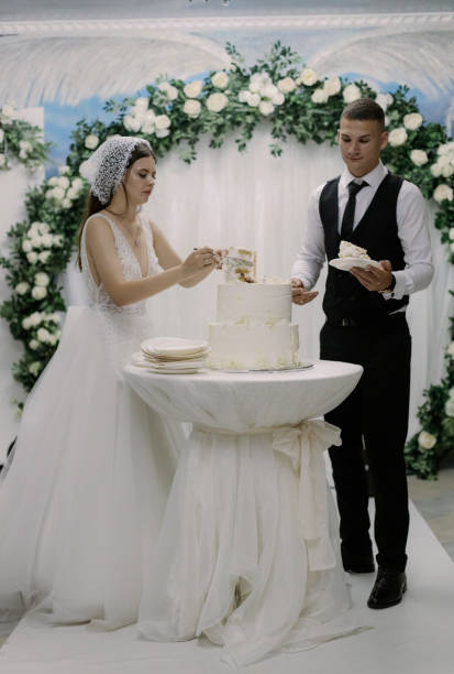 istock The bride and groom are serving the wedding cake. 2192286865