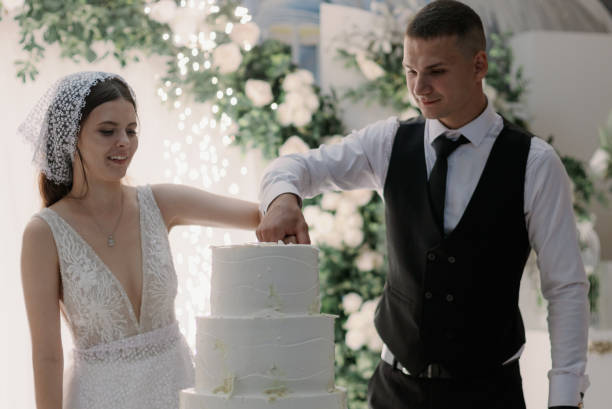 istock Happy bride and groom cutting the wedding cake. 2192287164
