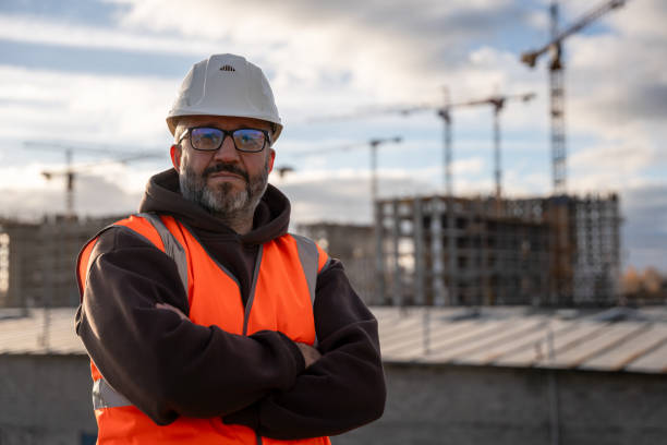 istock Construction Worker Wearing Safety Gear at Building Site 2192288173