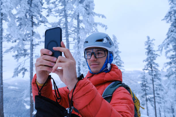 istock Portrait of backcountry skier using mobile phone in forest 2192288570