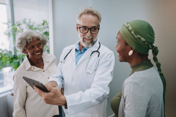 istock Oncologist shows tablet to patient accompanied by her mother 2192288886