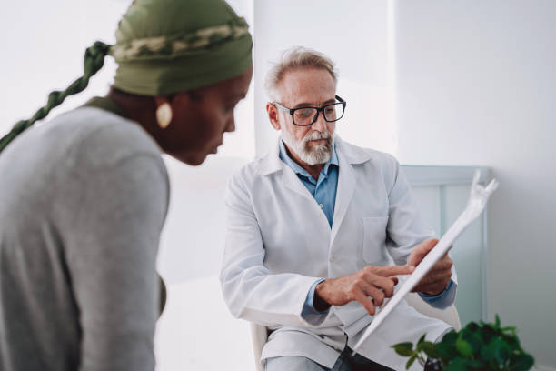 Oncologist talking to cancer patient