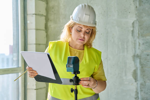 istock Technical profession woman in protective vest helmet working on construction 2192291714