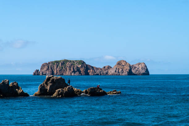 istock fishing on the rock at the seaside 2192291749