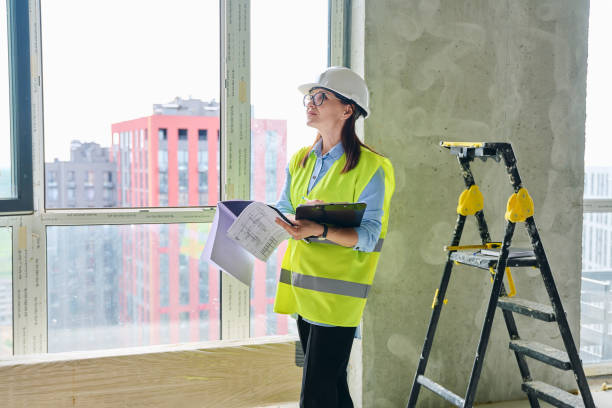 istock Technical profession woman in protective vest helmet working on construction 2192291780