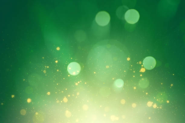 light green background with golden splashes of defocused particles. festive background for St. Patrick's Day light green background with golden splashes of defocused particles. festive background for St. Patrick's Day lucky jade stock illustrations