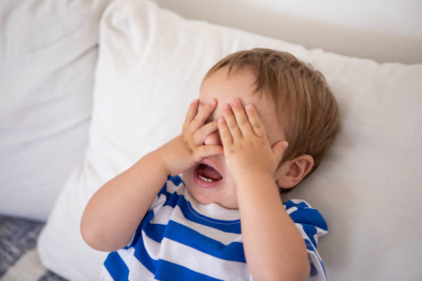 istock Cute baby boy playing hide and seek 2192291938