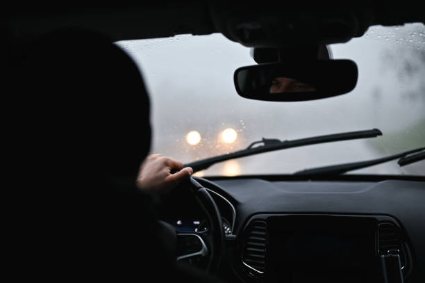 istock car driving in fog. 2192292202