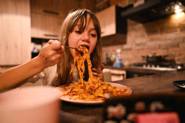 Child eating Italian pasta.