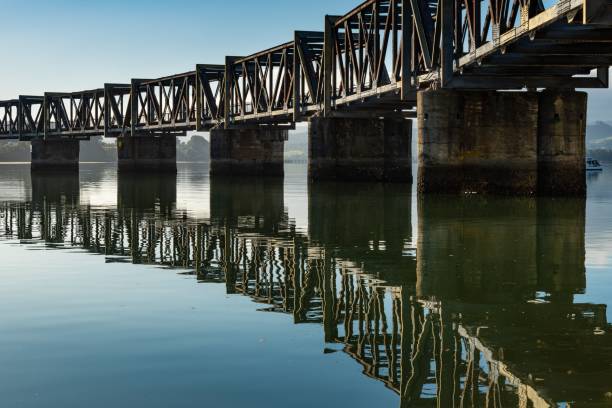 istock Serene view of a steel bridge over calm waters 2192294719