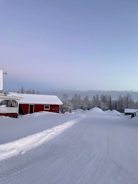 istock Winter landscape with red cabin and snowy road. 2192296240