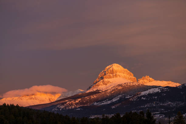 istock Alpen glow on mountain peak in winter snow 2192296582