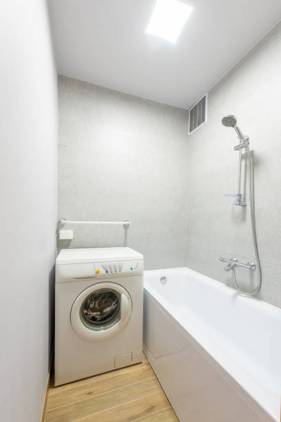 istock Modern Bathroom Interior with Bathtub and Washing Machine 2192297023