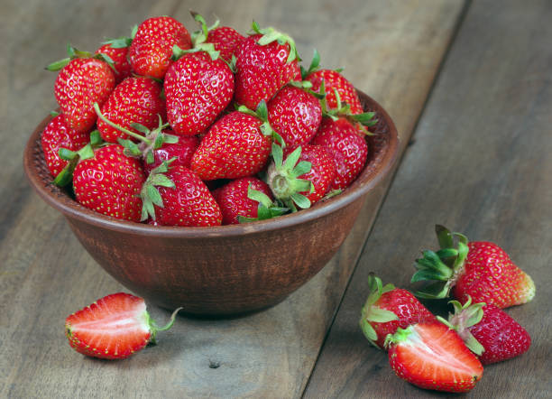 istock red ripe strawberries in bowl on a wooden table. 2192297148