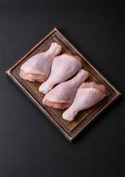 istock Raw chicken legs with salt, spices and herbs 2192301597
