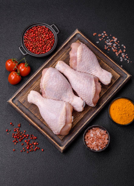 istock Raw chicken legs with salt, spices and herbs 2192301659